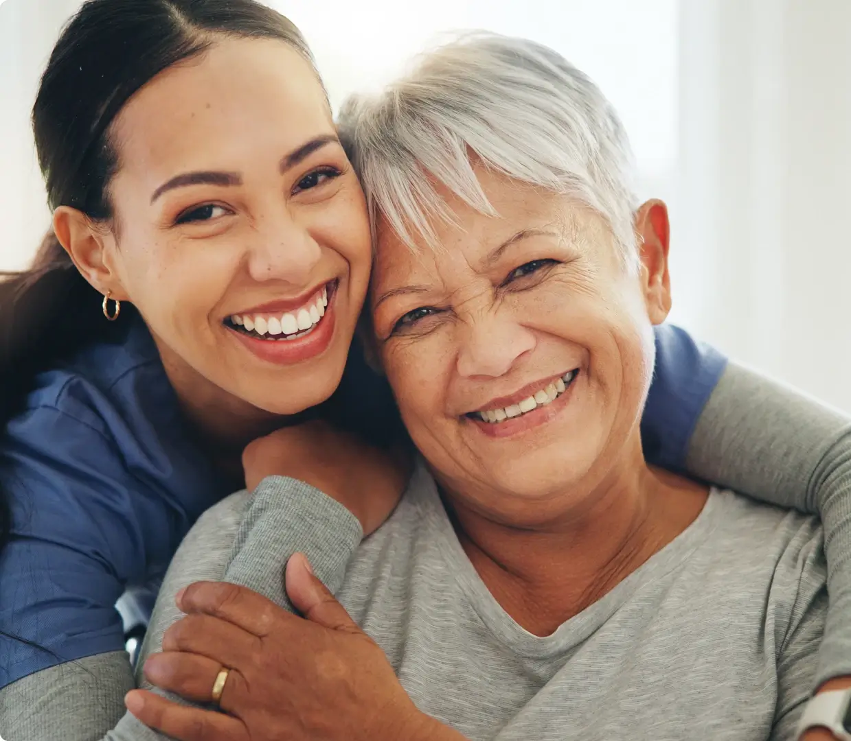 Caregiver smiling with a senior woman showing warmth and companionship